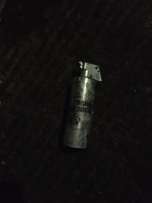 old small silver grenade can with green writing that says `TD Pocket Tactical green smoke`